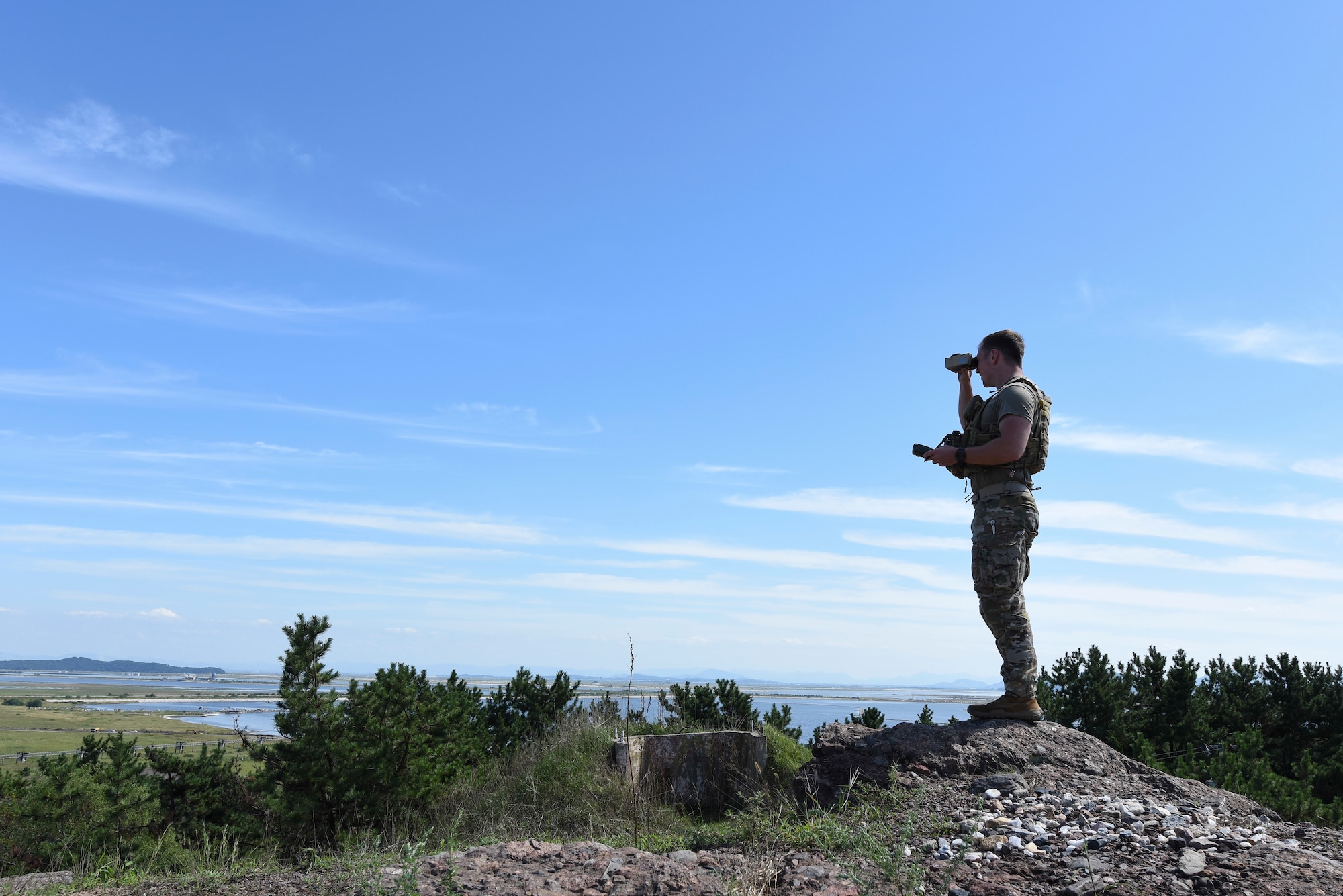 U.S. Air Force 1st Lt. Clay West, air liaison officer from the 15th Air Support Operations Squadron, Fort Stewart, Georgia, uses a pair of binoculars to pinpoint a potential target during joint terminal attack controller training Sept. 12, 2018 at Kunsan Air Base, Republic of Korea. The JTAC training integrated real world joint fire observers into a scenario with three-way communication maintained throughout the mission. (U.S. Air Force photo by Senior Airman Savannah L. Waters)