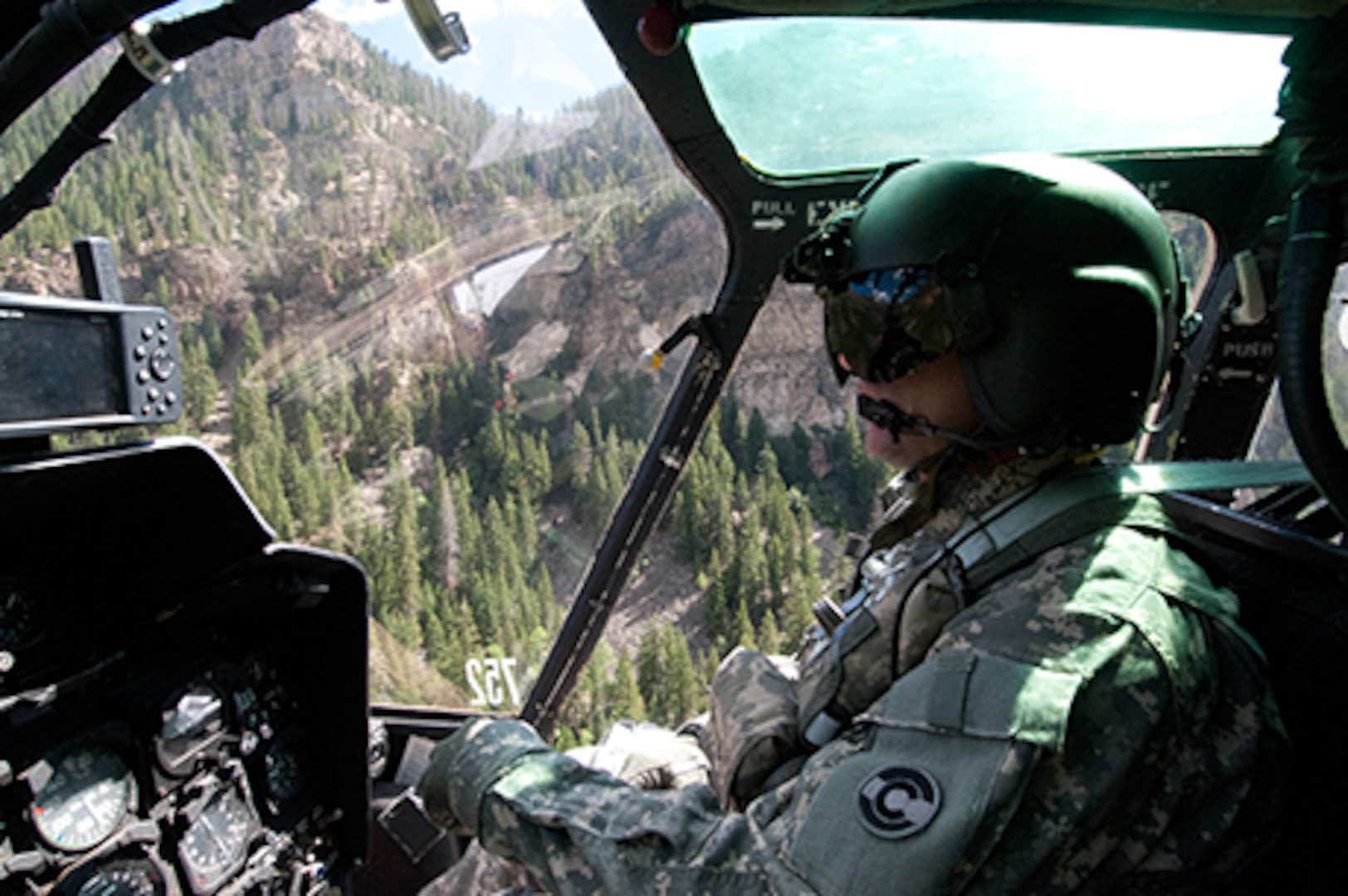 Colorado Army National Guard Maj. Tony Somogyi pilots his OH-58 Kiowa helicopter above the Rocky Mountains, Aug. 23, 2011. Somogyi is the executive officer of the COARNG’s High-altitude Army National Guard Aviation Training Site in Gypsum, Colo. Somogyi has extensive experience as a scout and as a search-and-rescue/search-and-recovery pilot. (Photo © 2011 Deborah Grigsby Illustrative Photography/Used with permission)