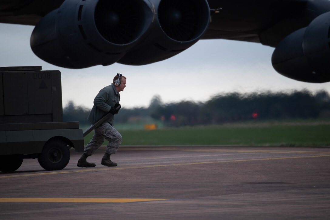 U.S. Air Force Tech. Sgt. Keith Hester, a B-52 Stratofortress crew chief assigned to the 343rd Expeditionary Squadron, prepares to hitch a generator to a truck at RAF Fairford, England, Sept. 11, 2018.   Hester was removing the equipment so the B-52 could taxi to the runway.  The sortie was part of Bomber Task Force operations at the base. (U.S. Air Force photo by Master Sgt. Ted Daigle)