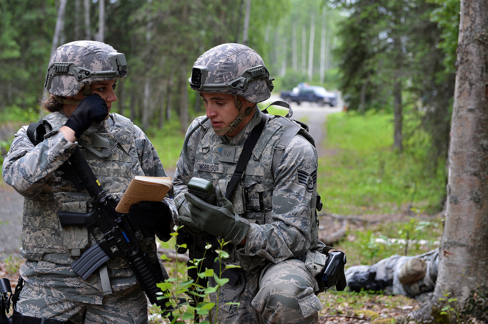 Airman 1st Class Shannon Costello and Staff Sergeant Michael Morrison, security forces specialists with the 155th Security Forces Squadron from the 155th Air Refueling Wing, Nebraska, report in an Improvised Explosive Device durning an IED awareness training exercise June 22, 2017, at Joint Base Elmendorf-Richardson, Alaska.