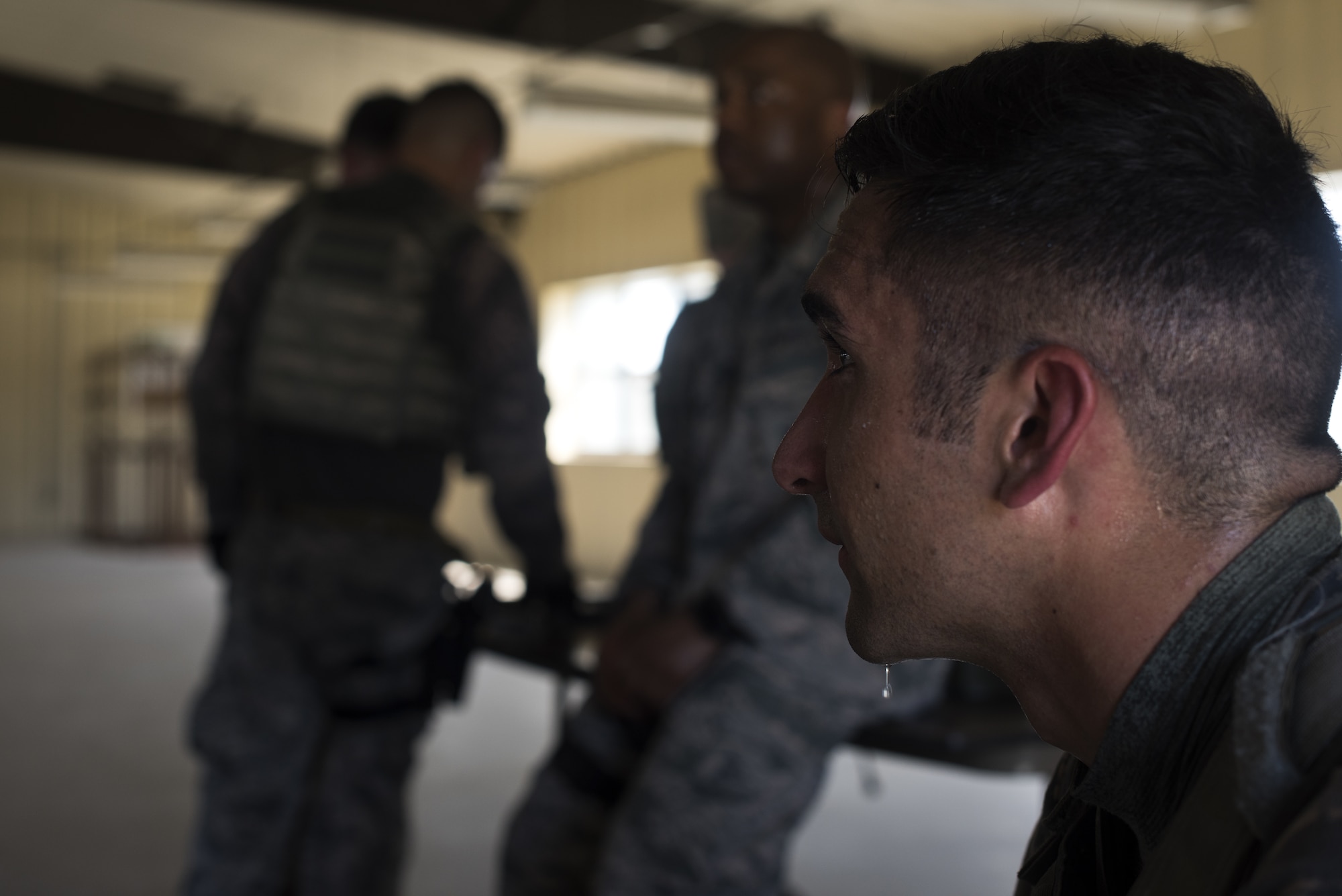 Sweat drips from the chin of Senior Airman Anthony Hu, MacDill Air Force Base, Fla., 6th Security Forces Squadron military working dog handler, after Hu endured hour of weapons training preparing him to represent Air Mobility Command in the 2018 Defender Challenge on Joint Base McGuire-Dix-Lakehurst, N.J., Sept. 4, 2018.Hu said he knew the training would be difficult but did not realize how non-stop it would be and how much he would treasure the five-minute breaks. (U.S. Air Force photo by Airman Ariel Owings)