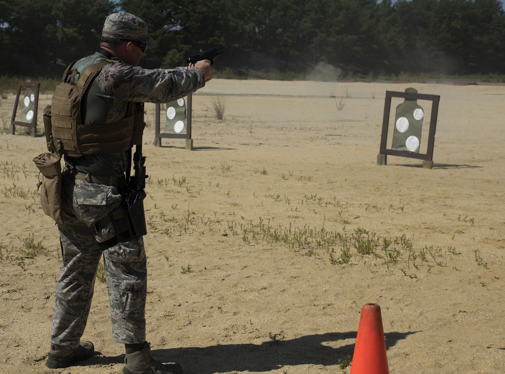 U.S. Air Force Staff Sgt. Luciano Rosano, 421st Security Forces Squadron combat training instructor, fires an m9 pistol during weapons training during preparation for representing Air Mobility Command in the 2018 Defender Challenge on Joint Base McGuire-Dix-Lakehurst, New Jersey, Sept. 4, 2018. Rosano qualified to be a part of the AMC team for the challenge by running a six-mile run while carrying 25-35 pounds. (U.S. Air Force photo by Airman Ariel Owings)