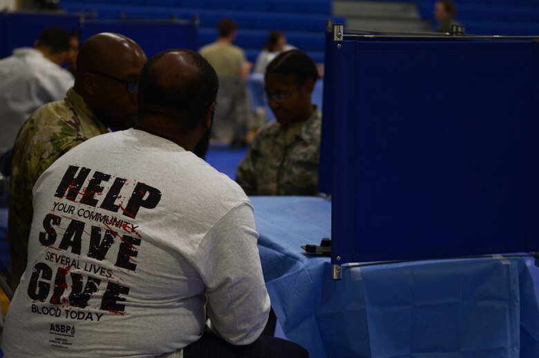 Armed Services Blood Program team members interview a potential donor at a blood drive at Royal Air Force Lakenheath, England, Sept. 18, 2018. Though there are factors that may disqualify a potential donor, most healthy individuals are eligible and encouraged to give blood to help those in need. (U.S. Air Force photo/Airman 1st Class Shanice Williams-Jones)