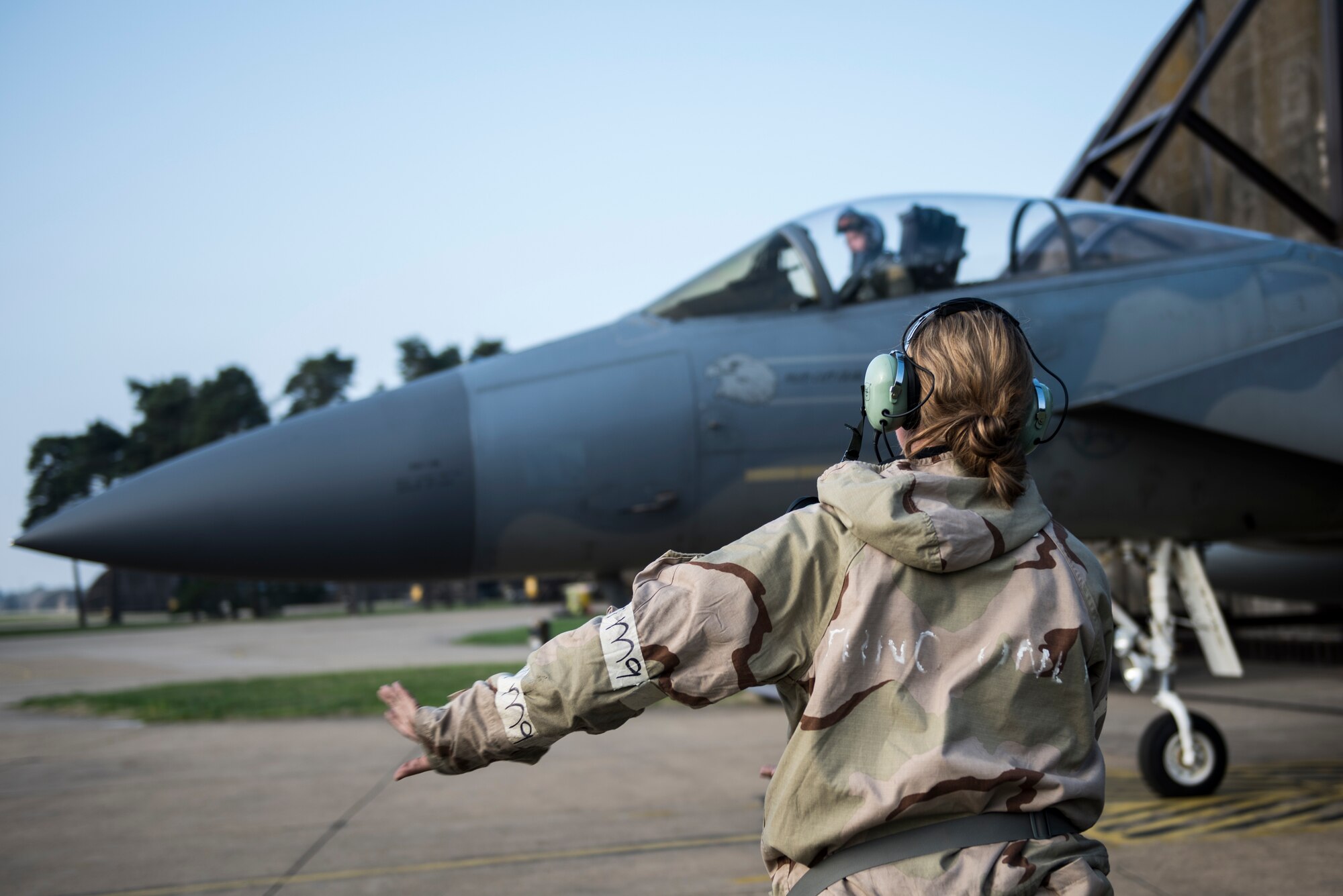 An Airman assigned to the 48th Maintenance Group sends off an F-15C Eagle for a sortie while in Mission Oriented Protective Posture gear during Combat Thursday at Royal Air Force Lakenheath, England, Sept. 6, 2018. Readiness remains a major focus of U.S. Air Force leadership, and is being fully integrated into operations with the 48th Fighter Wing’s top priorities and vision for the future at Royal Air Force Lakenheath, England. (U.S. Air Force photo/Senior Airman Malcolm Mayfield)