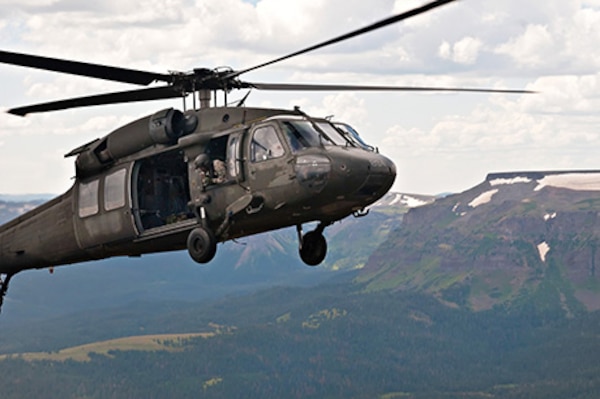 Active duty Army Chief Warrant Officer 3 Jonathan Licuanan and Chief Warrant Officer 3 Ryan Mahany take turns piloting a UH-60 Black Hawk in the Rocky Mountains of Colorado, while following the directions of their instructor pilot, Colorado Army National Guard Chief Warrant Officer 4 Mark Grayson, Aug. 25, 2011. Licuanan and Mahany are students at the COARNG’s High-altitude Army National Guard Aviation Training Site in Gypsum, Colo. Mahany has already flown in Afghanistan and Iraq and wishes he would have had this type of training prior to his deployments. (Photo © 2011 Deborah Grigsby Illustrative Photography/Used with permission)