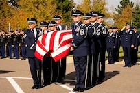 Members of the Colorado National Guard Honor Guard prepare to move Air Force Maj. Gen. John L. France (Ret.) casket to the commital shelter at Fort Logan National Cemetery, Denver, Colorado on 26 October 2015. Maj. Gen. France was the longest serving Adjutant General for the state of Colorado.(U.S. Army National Guard photo by Spc. Ray R. Casares/Released)