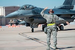 ​U.S. Air Force Tech. Sgt. Robbin Bruning, 140th Maintenance Squadron, Colorado Air National Guard, ushers in an F-16 Fighting Falcon during the wing’s readiness inspection at Buckley Air Force Base, Aurora, Colo., Oct. 16, 2015. This training is a part of the 140th Wing’s four-day Wing Wartime Readiness Inspection, the U.S. Air Force’s new evaluation system for wartime, contingency and force sustainment readiness. (U.S. Air National Guard photo by Tech. Sgt. Wolfram M. Stumpf)