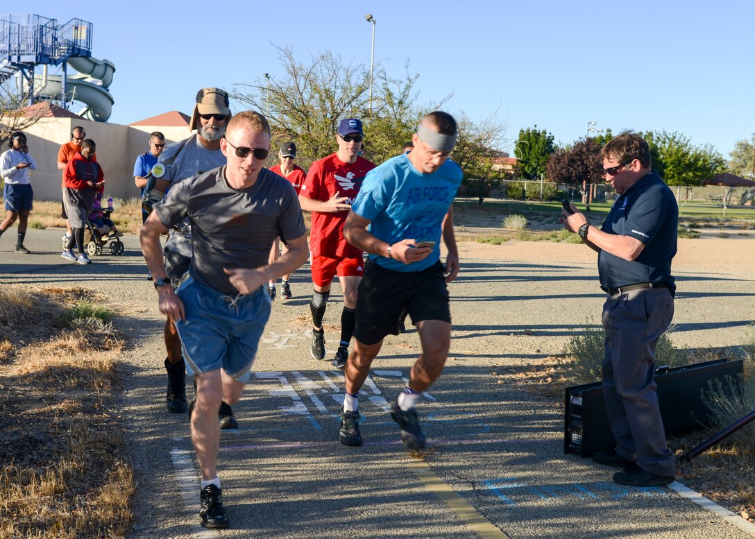 Participants take their first strides during Air Force Birthday 5k Run at Edwards Air Force Base, California, Sept. 18, 2018. The route took runners from the Youth Center parking lot through the desert, around the museum and back again. (U.S. Air Force photo by Giancarlo Casem)