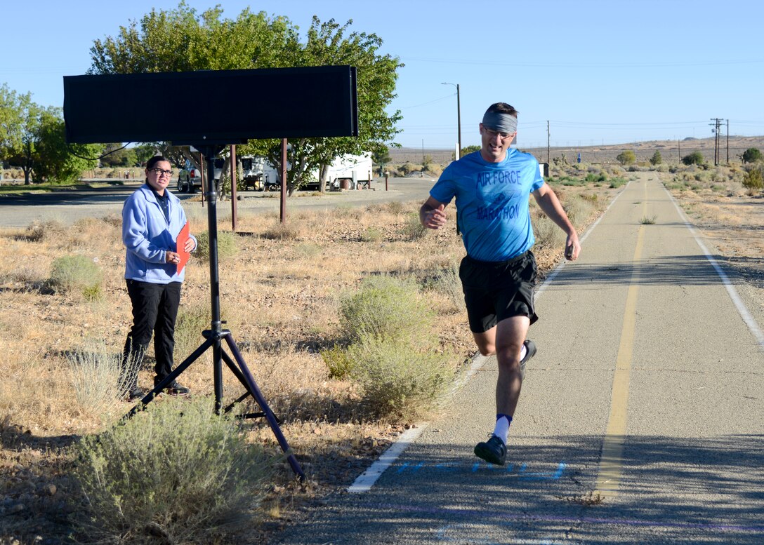 Maj. Brian Campion, Detachment 2, 9th Operations Group, crosses the finish line during the Air Force Birthday 5k Run at Edwards Air Force Base, California, Sept. 18, 2018. Campion finished the race in second place, over all. (U.S. Air Force photo by Giancarlo Casem)