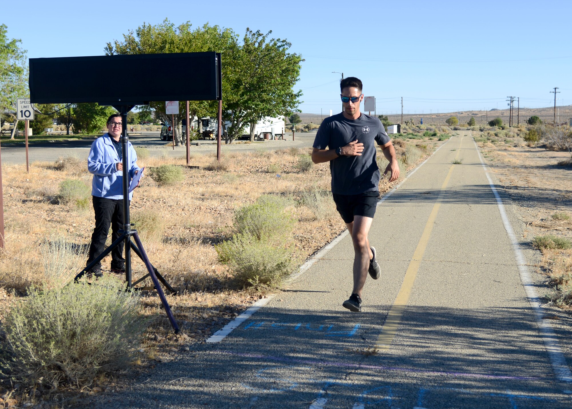 Matt Hinton, 412th Civil Engineer Group crosses the finish line during the Air Force Birthday 5k Run at Edwards Air Force Base, California, Sept. 18, 2018. Hinton finished the race in third place, over all. (U.S. Air Force photo by Giancarlo Casem)