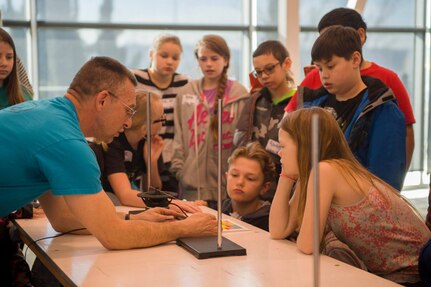 Steve Mastel, one of the coordinators for Puget Sound Naval Shipyard & Intermediate Maintenance Facility's science, technology, engineering and mathematics outreach program, talks with students about frequency generators during a Navy STEM day at the Puget Sound Navy Museum in Bremerton, Wash. PSNS & IMF's STEM outreach program was recently selected for a 2018 Community Service Award from Navy Region Northwest.