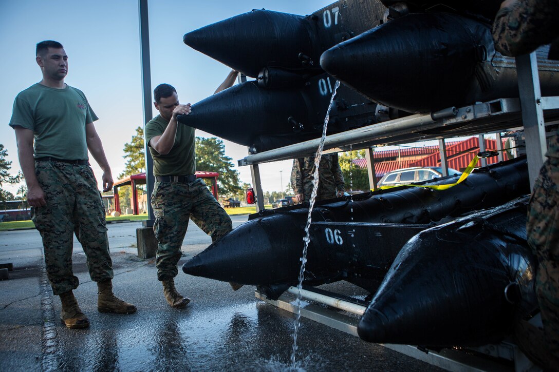 Marines with 3rd Force Reconnaissance Company, 4th Marine Division, empty excess water from a Combat Rubber Raiding Craft at the McCrady Training Center, South Carolina, Sept. 18, 2018, in preparation to respond to Hurricane Florence.