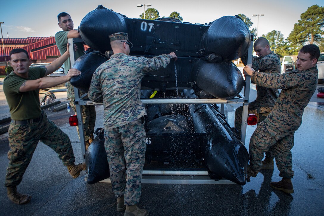 Marines with 3rd Force Reconnaissance Company, 4th Marine Division, empty water from a Combat Rubber Raiding Craft at the McCrady Training Center, South Carolina, Sept. 18, 2018, in preparation to respond to Hurricane Florence.
