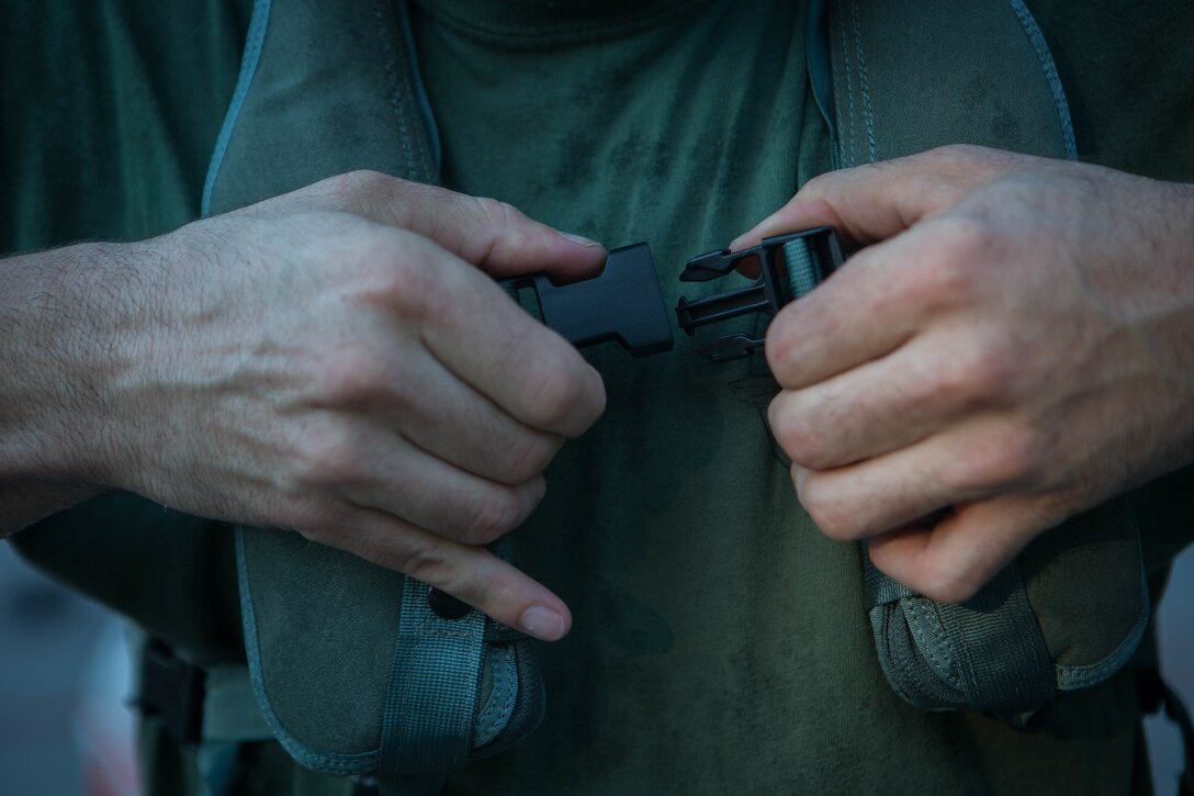 A Marine with 3rd Force Reconnaissance Company, 4th Marine Division, clips together his life-preserving device at the McCrady Training Center, South Carolina, Sept. 18, 2018, in preparation to respond to Hurricane Florence