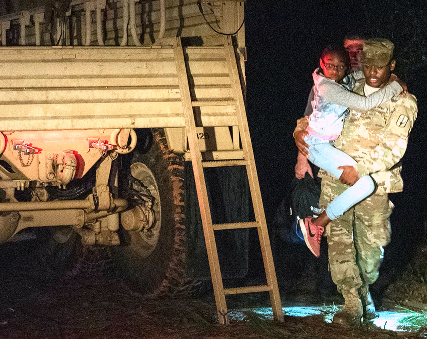 South Carolina Army National Guard Soldiers with the 1053rd Transportation Company assist a family that was trapped inside their vehicle during the early morning hours as a result of flood waters on the roadway in Hamer, South Carolina, Sept. 18.