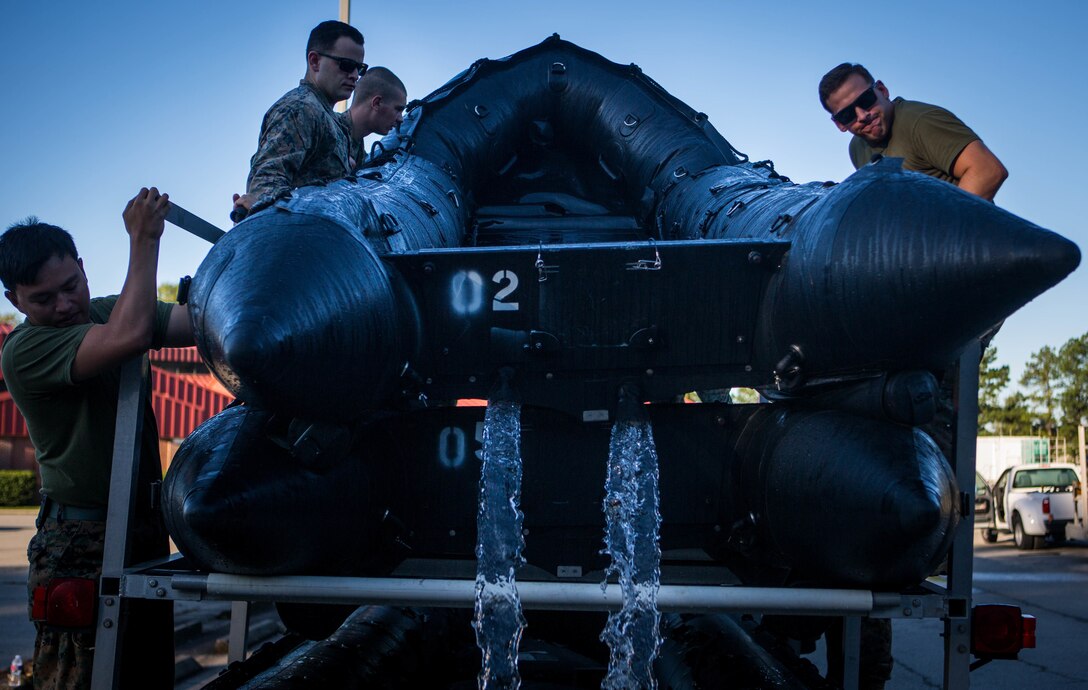 Marines with 3rd Force Reconnaissance Company, 4th Marine Division, empty excess water from a Combat Rubber Raiding Craft at the McCrady Training Center, South Carolina, Sept. 18, 2018, in preparation to respond to Hurricane Florence.