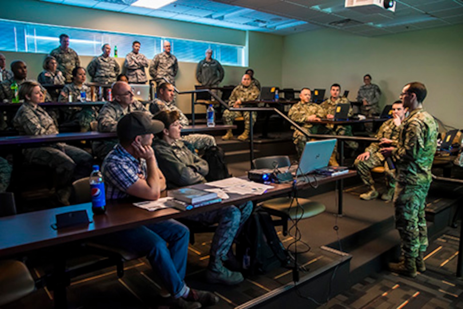 Chief Warrant Officer 2 Adam Johnston, of the Colorado National Guard's Defensive Cyber Operations Element, provides a briefing to the Joint Task Force - Centennial, about what the Vital Connection cyber exercise tests for and the overall process, at the Regis University training center in Greenwood Village, Colo., Feb. 12, 2017. (U.S. Air National Guard Photo by Maj. Darin Overstreet)