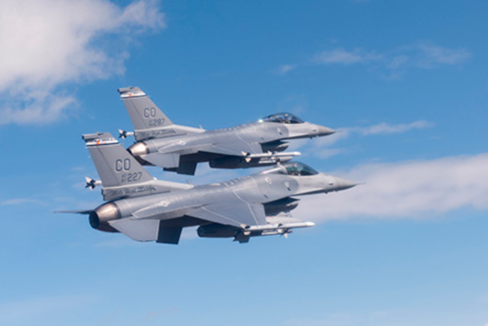 Two U.S. Air Force F-16 Fighting Falcons from the 120th Fighter Squadron, Colorado Air National Guard, fly together during a photo chase mission around Denver Colo. May 29, 2015. (U.S. Air National Guard photo by, Tech. Sgt. Wolfram M. Stumpf)(RELEASED)