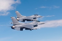 Two U.S. Air Force F-16 Fighting Falcons from the 120th Fighter Squadron, Colorado Air National Guard, fly together during a photo chase mission around Denver Colo. May 29, 2015. (U.S. Air National Guard photo by, Tech. Sgt. Wolfram M. Stumpf)(RELEASED)