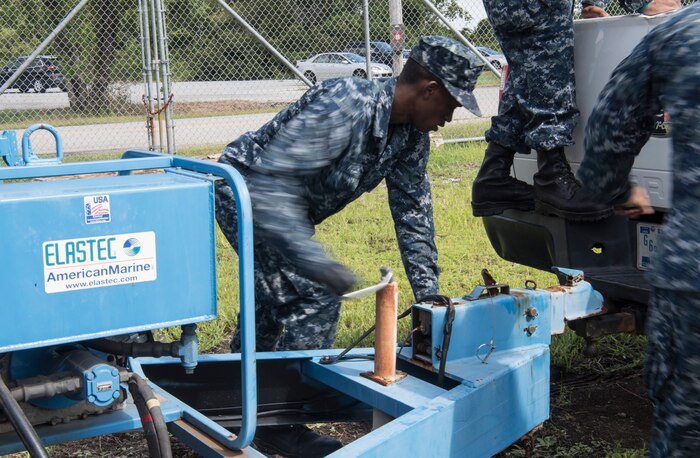 U.S. Navy Seaman Darien Kelly, Harbor Patrol Unit, unhooks a trailer hitch Sept. 17, 2018, at Joint Base Charleston, S.C. Team members are resuming normal operations after Hurricane Florence moving equipment and material back into service from sheltered storage.