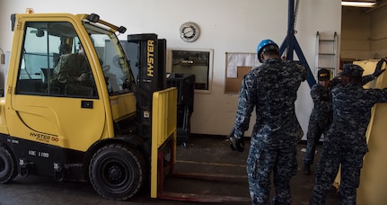 Sailors from the Harbor Patrol Unit move materials with a forklift Sept. 17, 2018, at the Naval Weapons Station’s port operations building at Joint Base Charleston, S.C. Team members are resuming normal operations after Hurricane Florence by moving equipment and material back into service from sheltered storage.