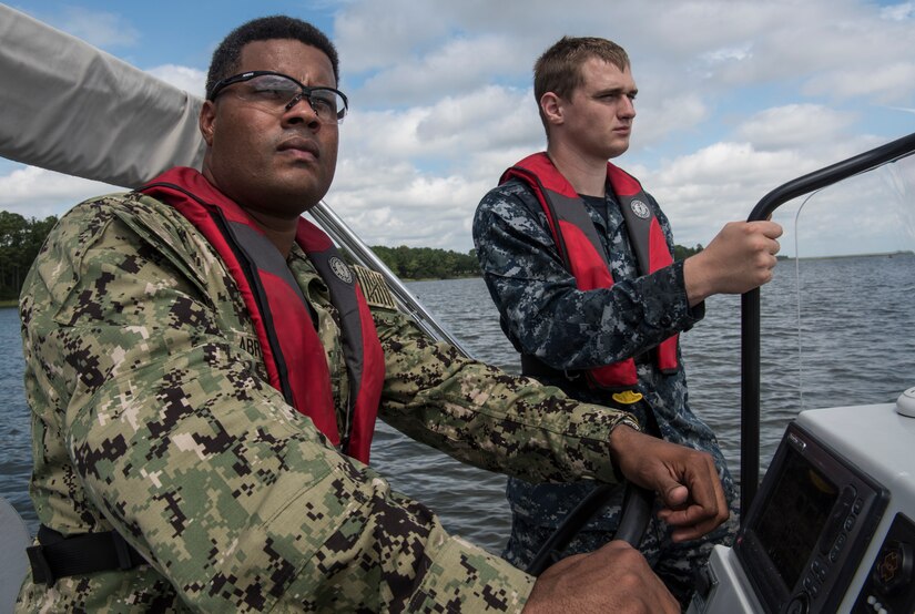 U.S. Navy Aviation Boatswain’s Mate 1st Class Joan R. Abreu, left, Harbor Patrol Unit and U.S. Navy Machinist Mate 3rd Class William Wilkes, Harbor Patrol Unit, go on a patrol Sept. 17, 2018, to check for damage to the docks on the waterfront at Joint Base Charleston, S.C. The unit is assessing and fixing damage from Hurricane Florence.