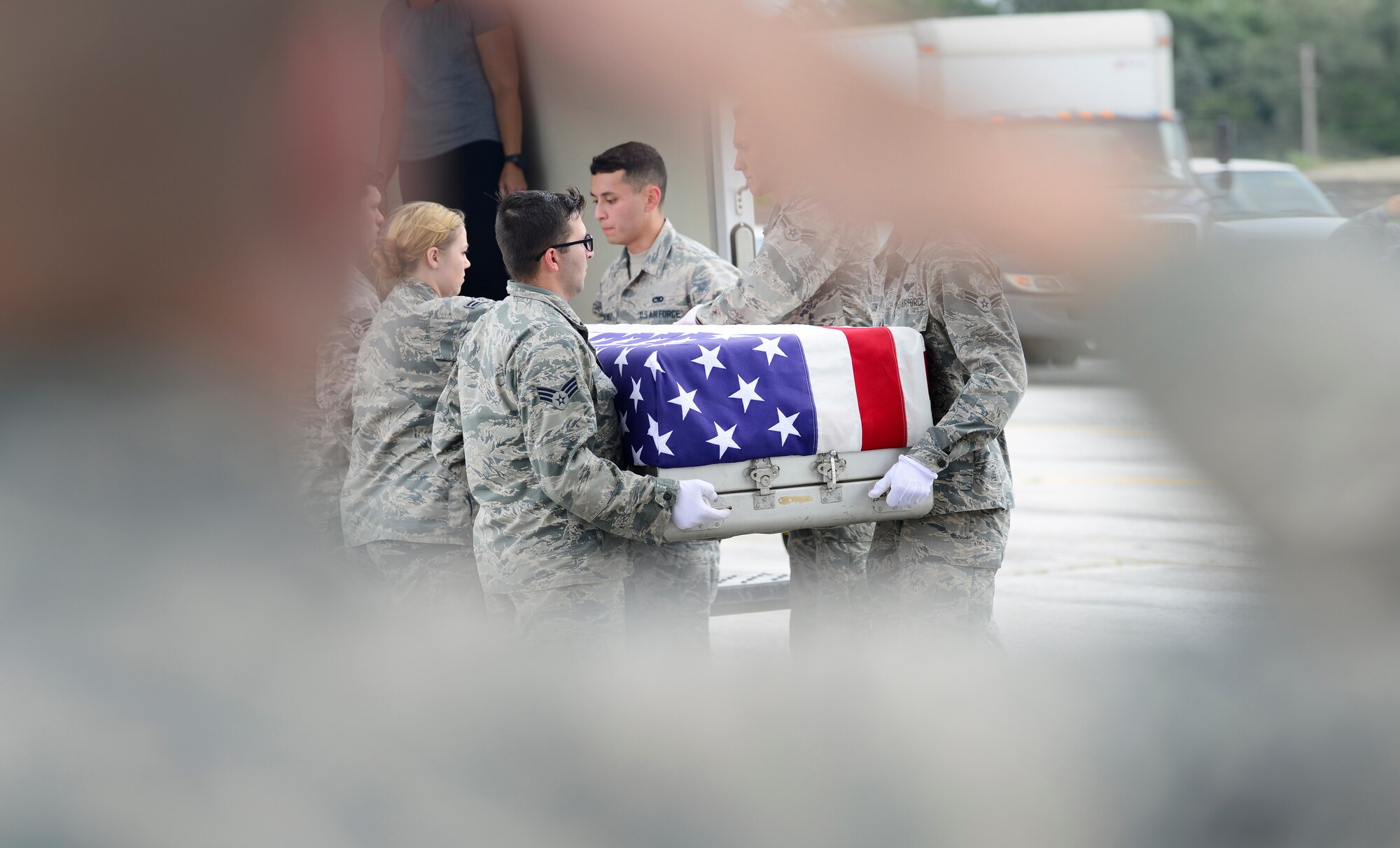 Attendees salute the remains of WWII heroes as they are moved during a flight line ceremony Sept. 14, 2018, at Offutt Air Force Base, Nebraska. Aircrew from Joint Base Charleston, S.C. was tasked to deliver the remains due to its rapid mobility capabilities.