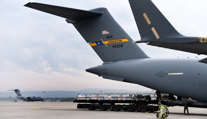 26 transfer cases of WWII human remains get loaded onto a C-17 Globemaster III for a repatriation Sept. 13, 2018, at Ramstein Air Base, Germany. Aircrew from Joint Base Charleston, S.C. was tasked to deliver the remains due to its rapid mobility capabilities.