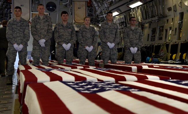 Airmen participate in a ceremony honoring 26 WWII human remains Sept. 14, 2018, at Offutt Air Force Base, Nebraska.  Aircrew from Joint Base Charleston, S.C. was tasked to deliver the remains due to its rapid mobility capabilities.