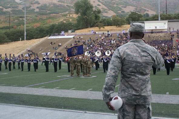 Brig. Gen. Stacey Hawkins, Ogden Air Logistics Complex commander, renders honors to the flag during the National Anthem at the Weber State University Hill Air Force Base Appreciation Game Sept. 15, 2018, at Stewart Stadium in Ogden. Hawkins received the game ball as part of the opening ceremony. (U.S. Air Force photo by Jennifer Eaton)