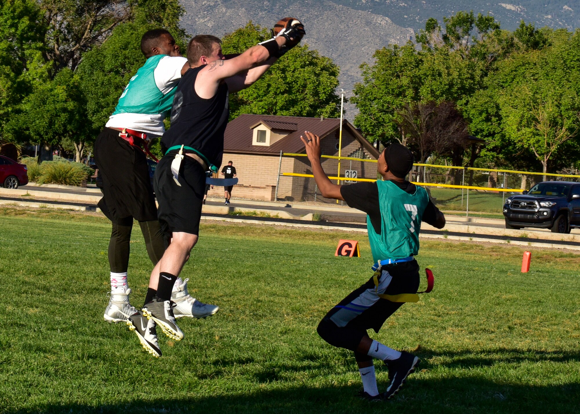 Tech. Sgt. Matthew Miller, safety for the 58th AMXS flag football team, intercepts a pass between two members of the WSSS-Joseph flag football team at Kirtland Air Force Base, N.M., Sept. 17, 2017. Each football game is split into two halves with each half lasting 20 minutes. (U.S. Air Force photo by Airman Austin J. Prisbrey)