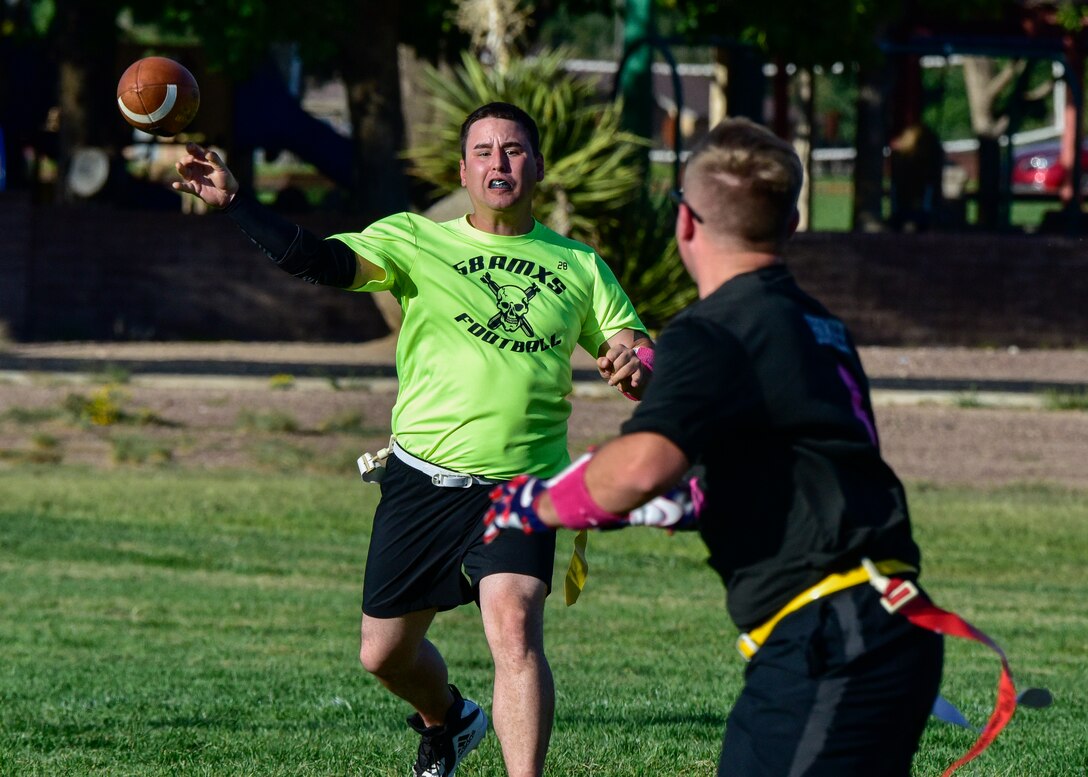 Staff Sgt. William Hopkins, quarterback for the 58th AMXS flag football team, throws the football to Staff Sgt. Matthew Frame, receiver for the 58th AMXS flag football team at Kirtland Air Force Base, N.M., Sept. 17, 2018. The 58th AMXS flag football team is 0-3 after this loss. (U.S. Air Force photo by Airman Austin J. Prisbrey)