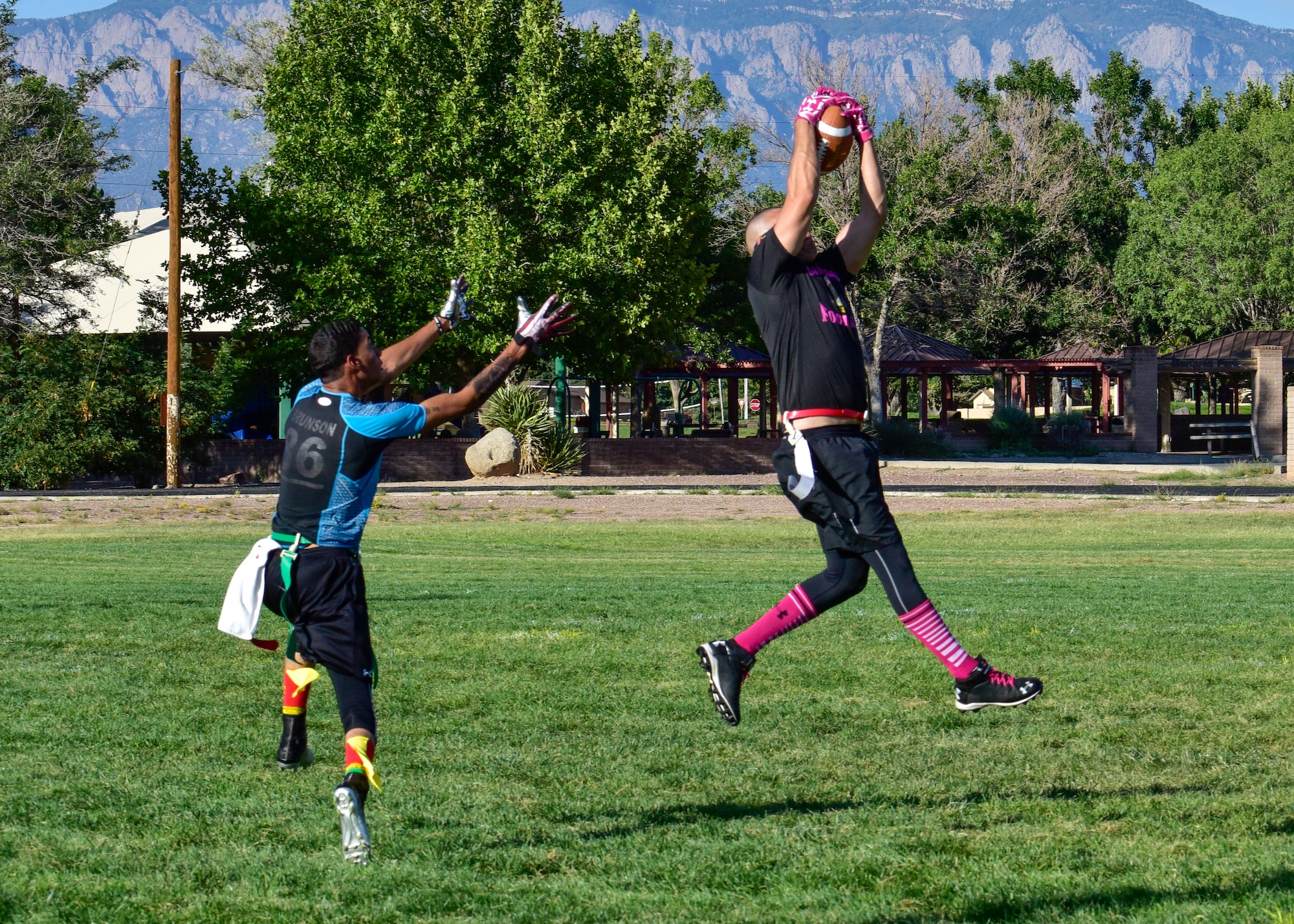 Staff Sgt. Mark Birrenkott, safety for the 58th AMXS flag football team, intercepts a pass intended for Airman 1st Class Patrick Brunson, wide receiver for the WSSS-Joseph football team at Kirtland Air Force Base, N.M., Sept. 17, 2018. Each team participating in the 2018 KAFB Intramural Flag Football season will play 18 games during the regular season. (U.S. Air Force photo by Airman Austin J. Prisbrey)