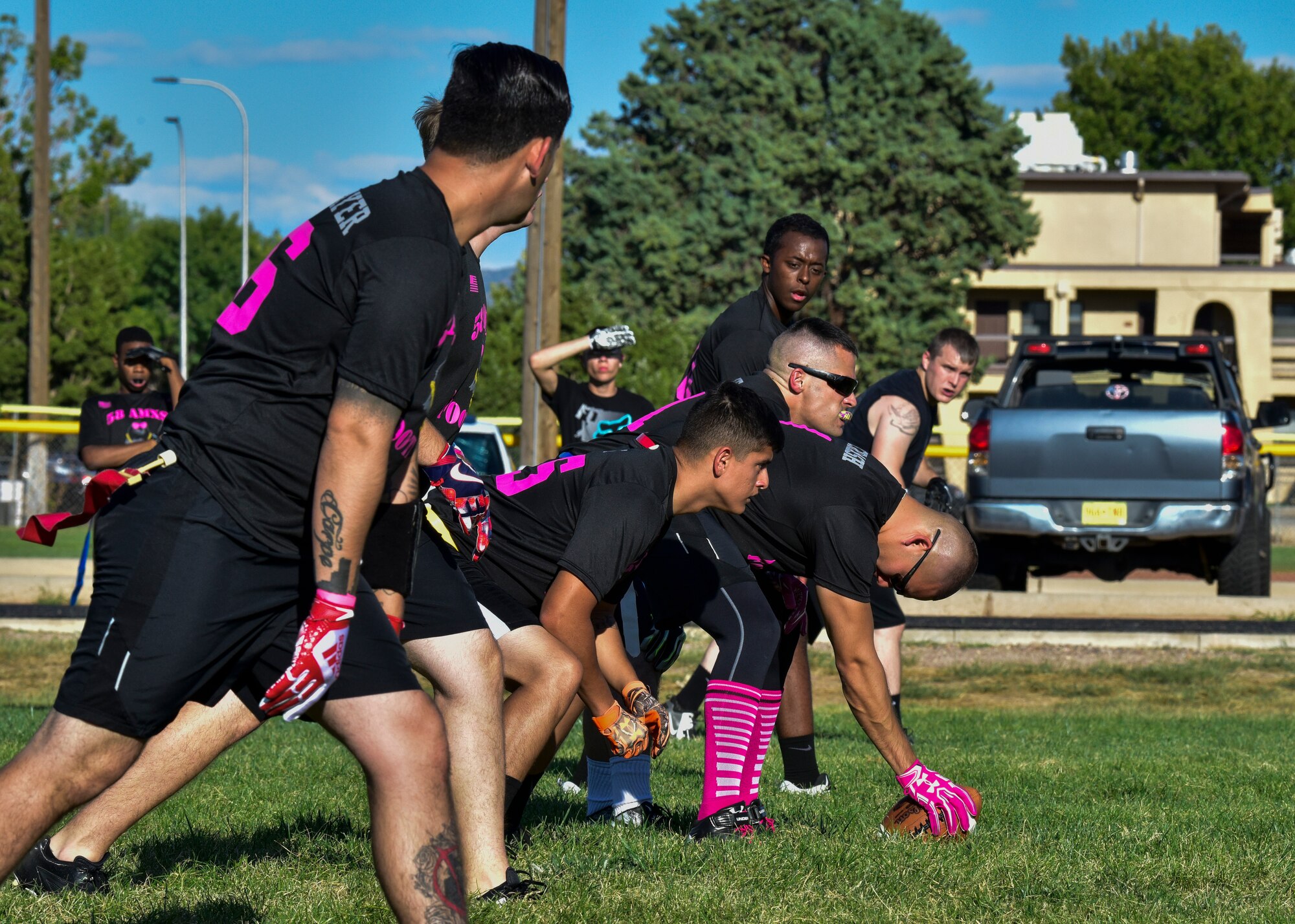 Members of the 58th AMXS flag football team line up prior to the snap at Kirtland Air Force Base, N.M., Sept. 17, 2018. There are eight teams participating in the 2018 KAFB Intramural Flag Football season this year. A playoff tournament is scheduled to be held after the regular season to determine an overall winner.  (U.S. Air Force photo by Airman Austin J. Prisbrey)