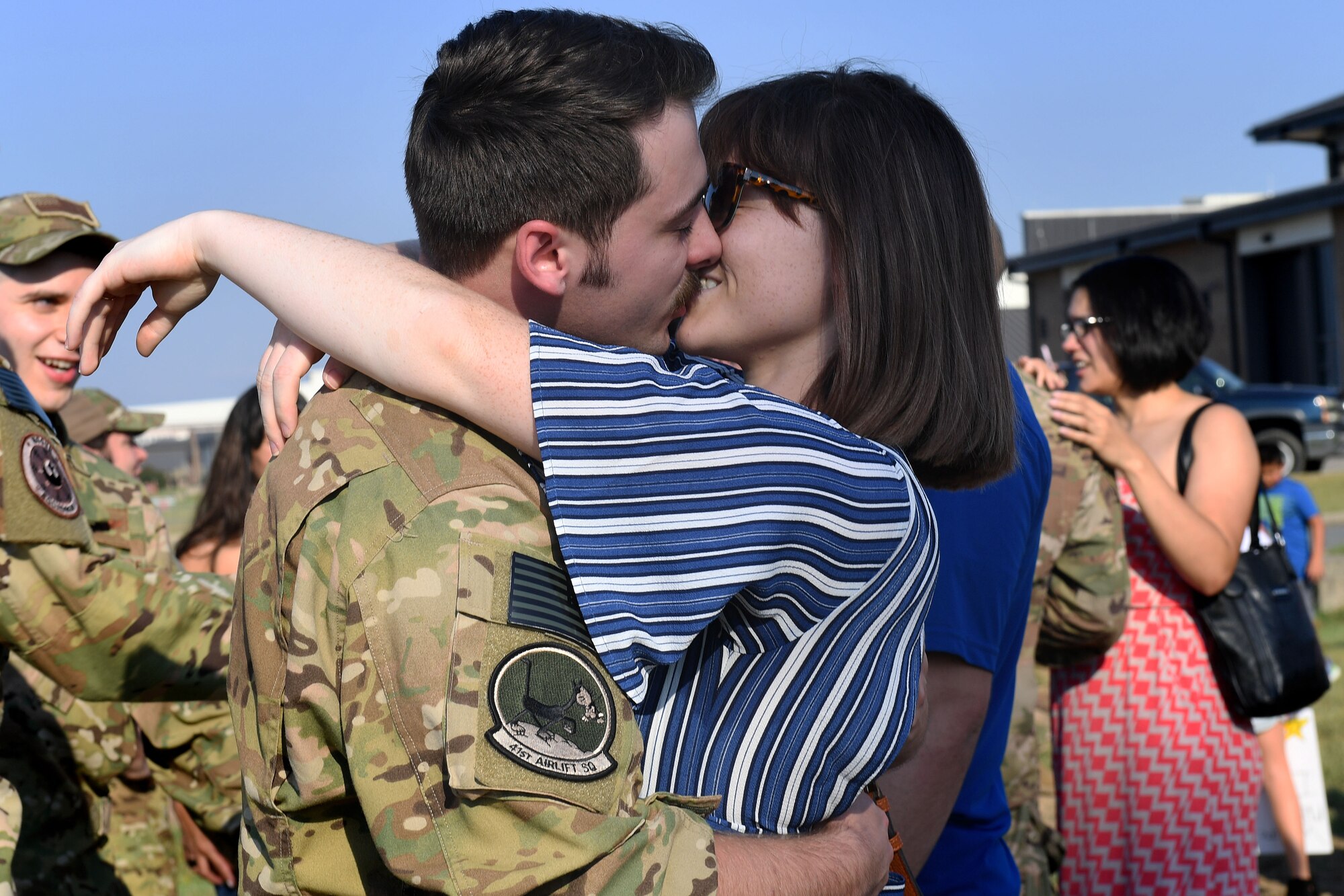 Man kisses a woman.