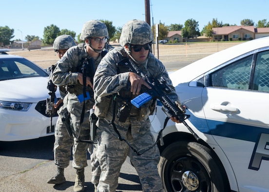 Members of the 412th Security Forces Squadron “stack” behind a vehicle as they prepare to secure a crime scene during Desert Wind 18-03, an active shooter scenario exercise at Desert Junior-Senior High School at Edwards Air Force Base, California, Sept. 18, 2018. (U.S. Air Force photo by Giancarlo Casem)