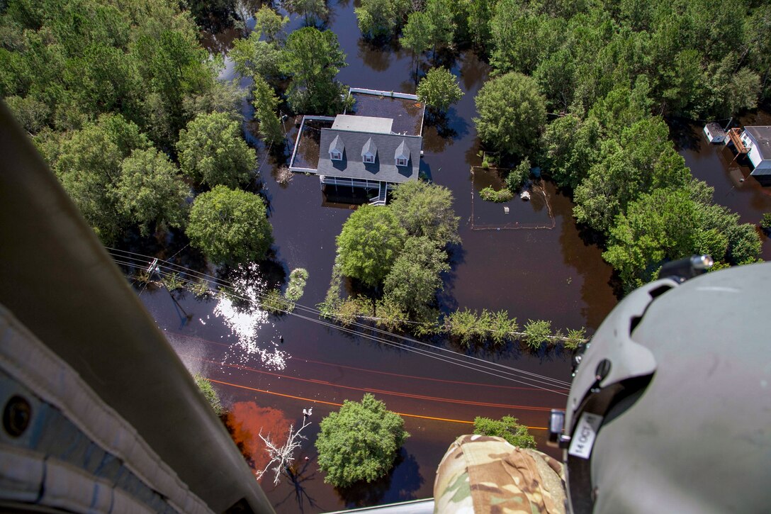 National Guardsmen fly over areas affected by Hurricane Florence.