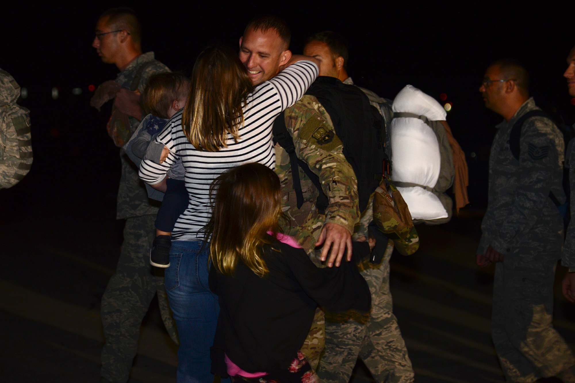 Master Sgt. Steven Graff, the 28th Maintenance Squadron noncommissioned officer in charge of egress, hugs his family as he lands back at Ellsworth Air Force Base, S.D., after a six-month deployment to Al Udeid Air Base, Qatar, Sept. 18, 2018. The 28th Bomb Wing deployed B-1s, Airmen and support equipment to fly missions in the U.S. Central Command area of responsibility. (U.S. Air Force photo by Senior Airman Denise M. Jenson)