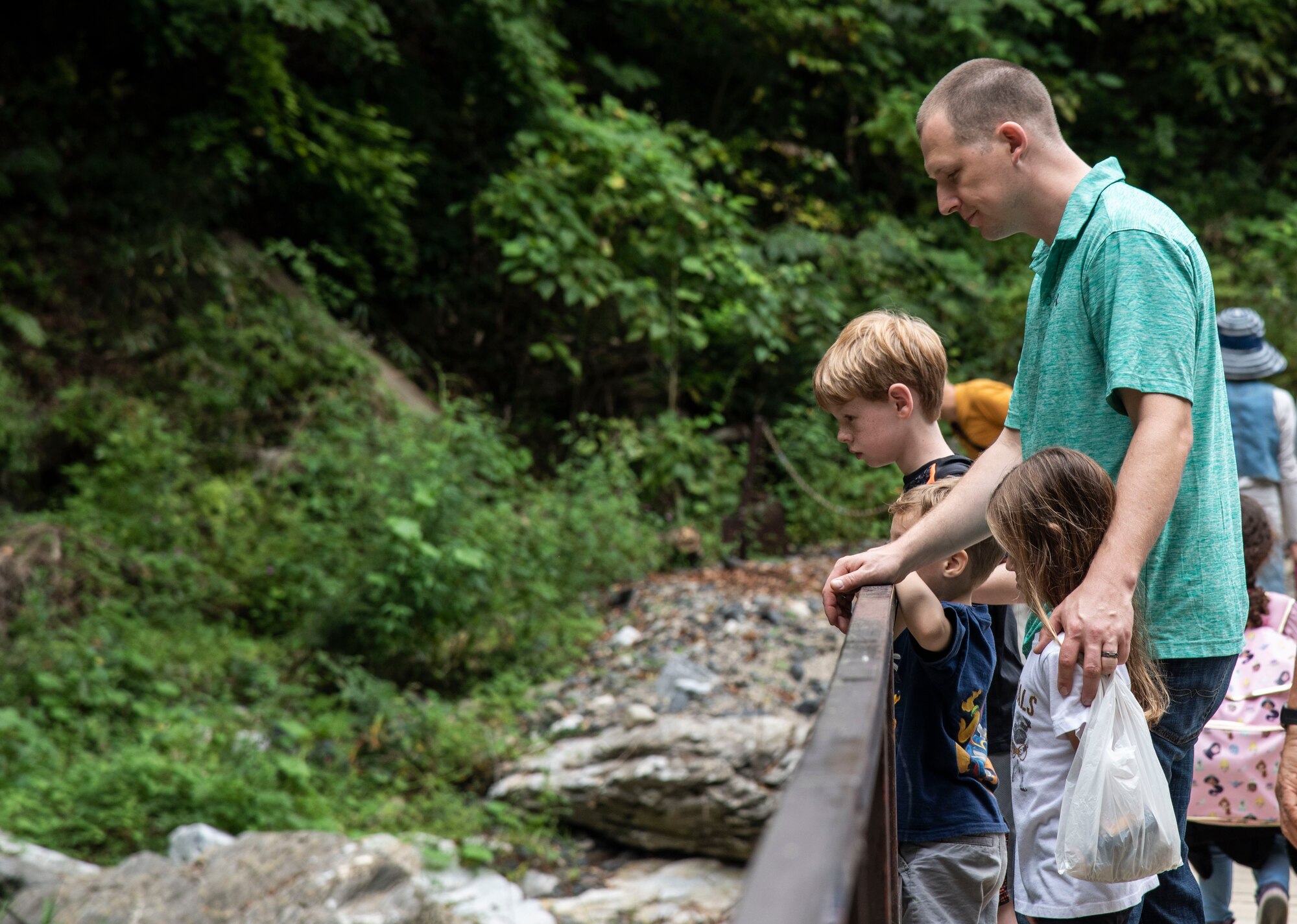 U.S. Air Force Capt. Joshua Hammans, a 35th Fighter Wing chaplain, and his children, look at a water stream during a 35th Fighter Wing chapel resiliency trip, at Ichinoseki, Japan, Sept. 15, 2018. The chapel took approximately 40 active-duty personnel and their dependents to Geibikei Gorge and Chuson-Ji Temple, Hiraizumi, Japan, in order to strengthen their spiritual and social aspects of the Comprehensive Airmen's Fitness pillars. According to Air Force studies, when Airmen are spiritually, physically, mentally and socially resilient, they reach optimal performance in their daily tasks, better executing the mission. (U.S. Air Force photo by Senior Airman Sadie Colbert)