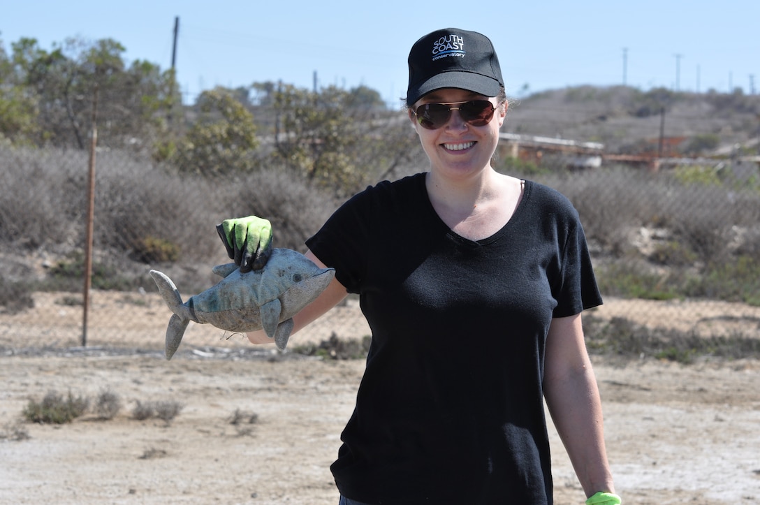 Jill Prunella of Costa Mesa, California, holds up a stuffed dolphin she found while picking up trash during the Santa Ana River Marsh Cleanup Day Sept. 15 in Newport Beach, California. Some of the other unusual objects volunteers found included a boot, printer cartridge, tires and an assortment of balls. The event was part of California Coastal Cleanup Day.