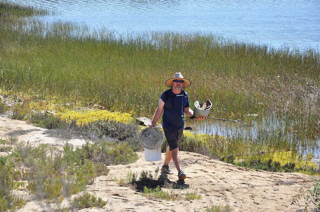 A volunteer hauls in trash from the Santa Ana River Marsh Sept. 15 at Newport Beach, California. The event was part of California Coastal Cleanup Day.
