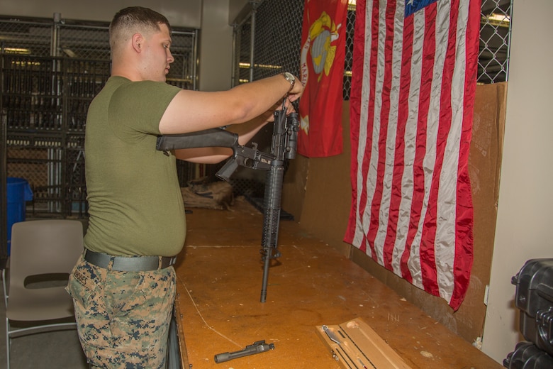 Lance Cpl. Joey Rhodes inspects a M16 A4 service rifle Aug. 9, 2018 at the Camp Foster armory, Okinawa, Japan.