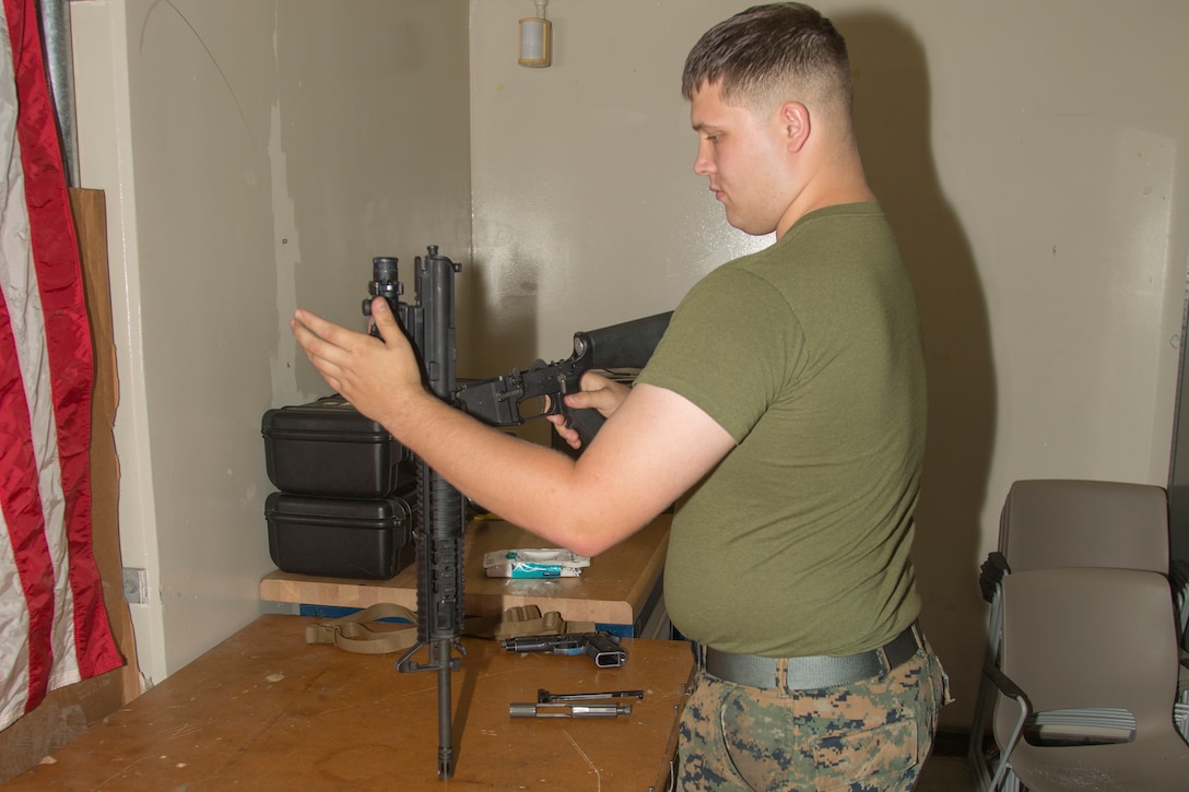 Lance Cpl. Joey Rhodes inspects a M16 A4 service rifle Aug. 9, 2018 at the Camp Foster armory, Okinawa, Japan.