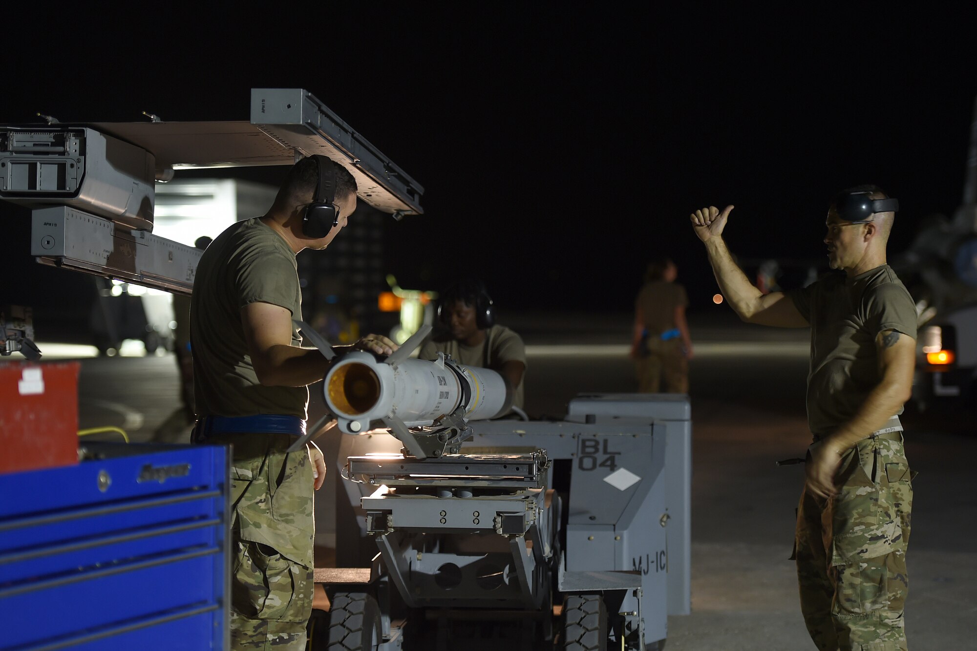 Airmen work on the flightline at night