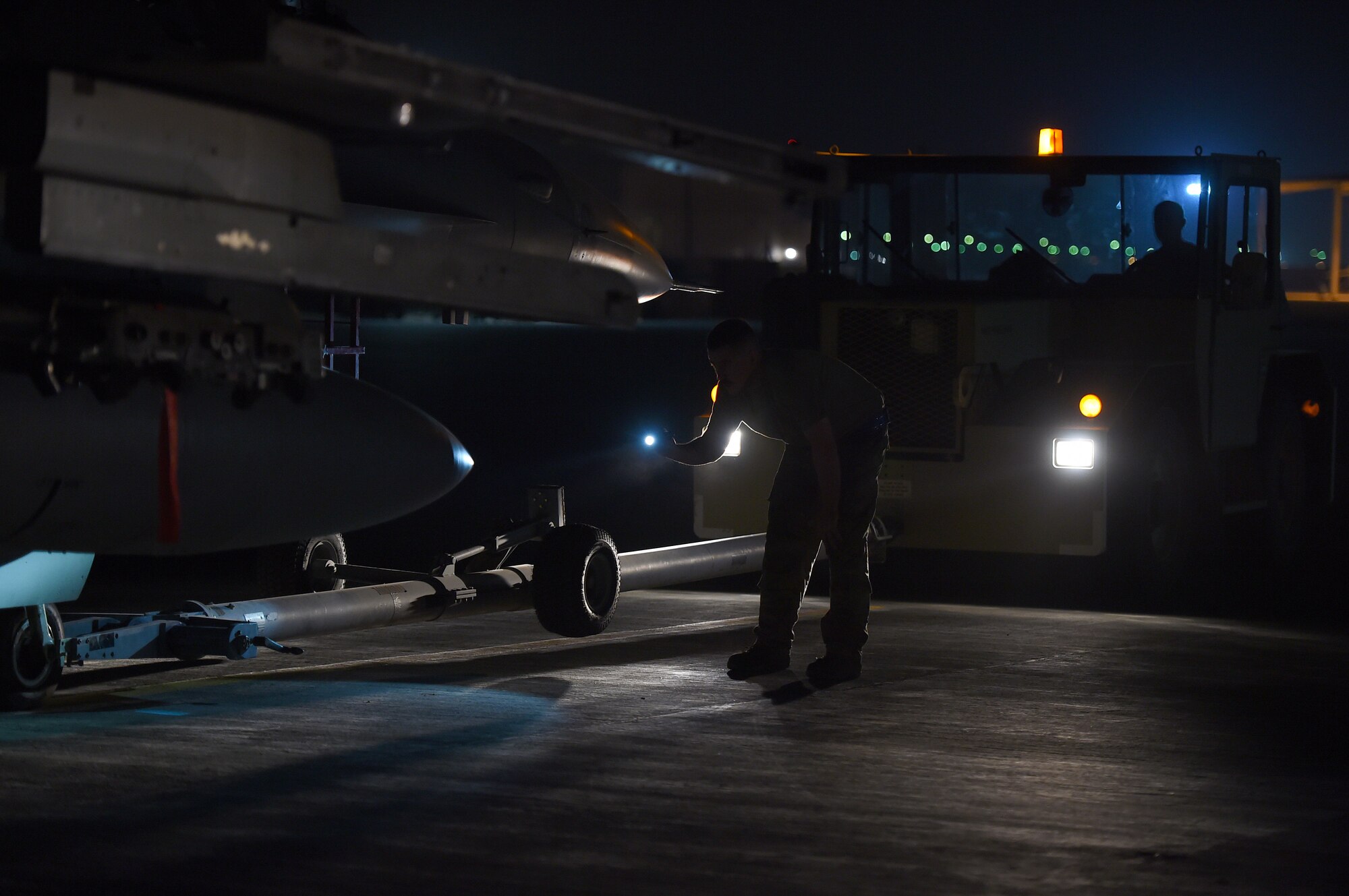 Airmen work on the flightline at night