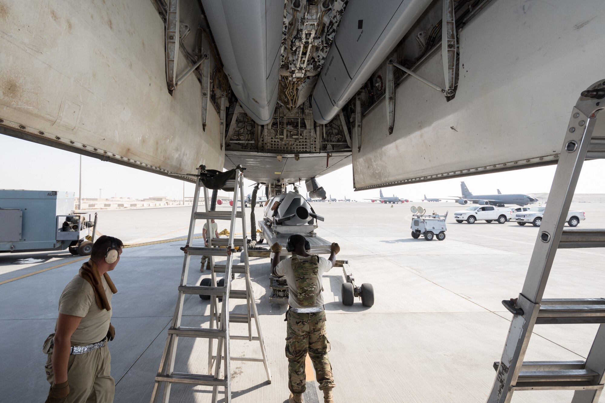 Weapons load crews assigned to the 9th Expeditionary Bomb Squadron conduct a training exercise on the B-1B Lancer with inert munitions at Al Udeid Air Base, Qatar, Sept. 13, 2018. The event involved reconfiguring the aircraft with inert munitions to maintain a high state of readiness. The B-1B Lancer carries the largest conventional payload of both guided and unguided weapons in the Air Force inventory and is the backbone of America's long-range bomber force. It can rapidly deliver massive quantities of precision and non-precision weapons against any adversary, anywhere in the world, at any time. Its armaments include up to 24 AGM-158A Joint Air-to-Surface Standoff Munitions. (U.S. Air Force photo by Tech. Sgt. Ted Nichols/Released)