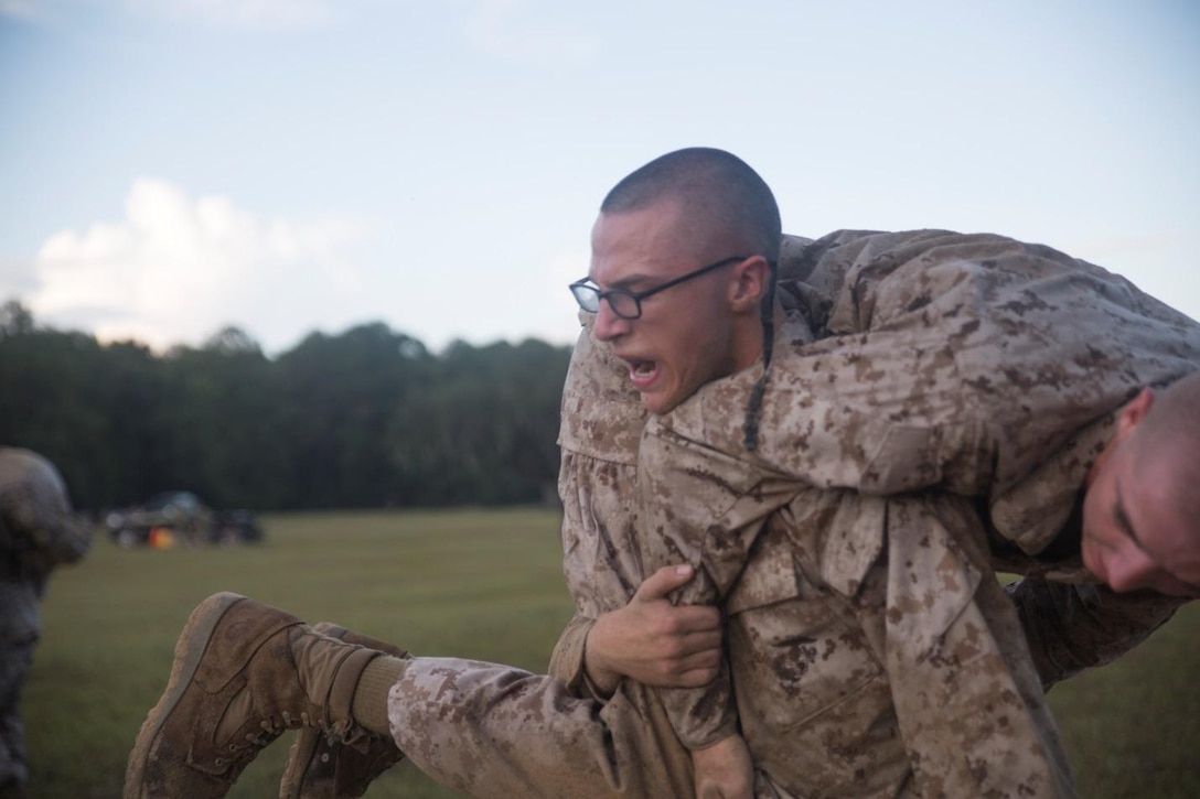 Recruit Ethan Gemzik with Platoon 3080, Mike Company, 3rd Recruit Training Battalion conducts a “fireman carry” during the Marine Corps Martial Arts Program Endurance Course Sep. 08, 2018, on Marine Corps Depot Parris Island, S.C.
