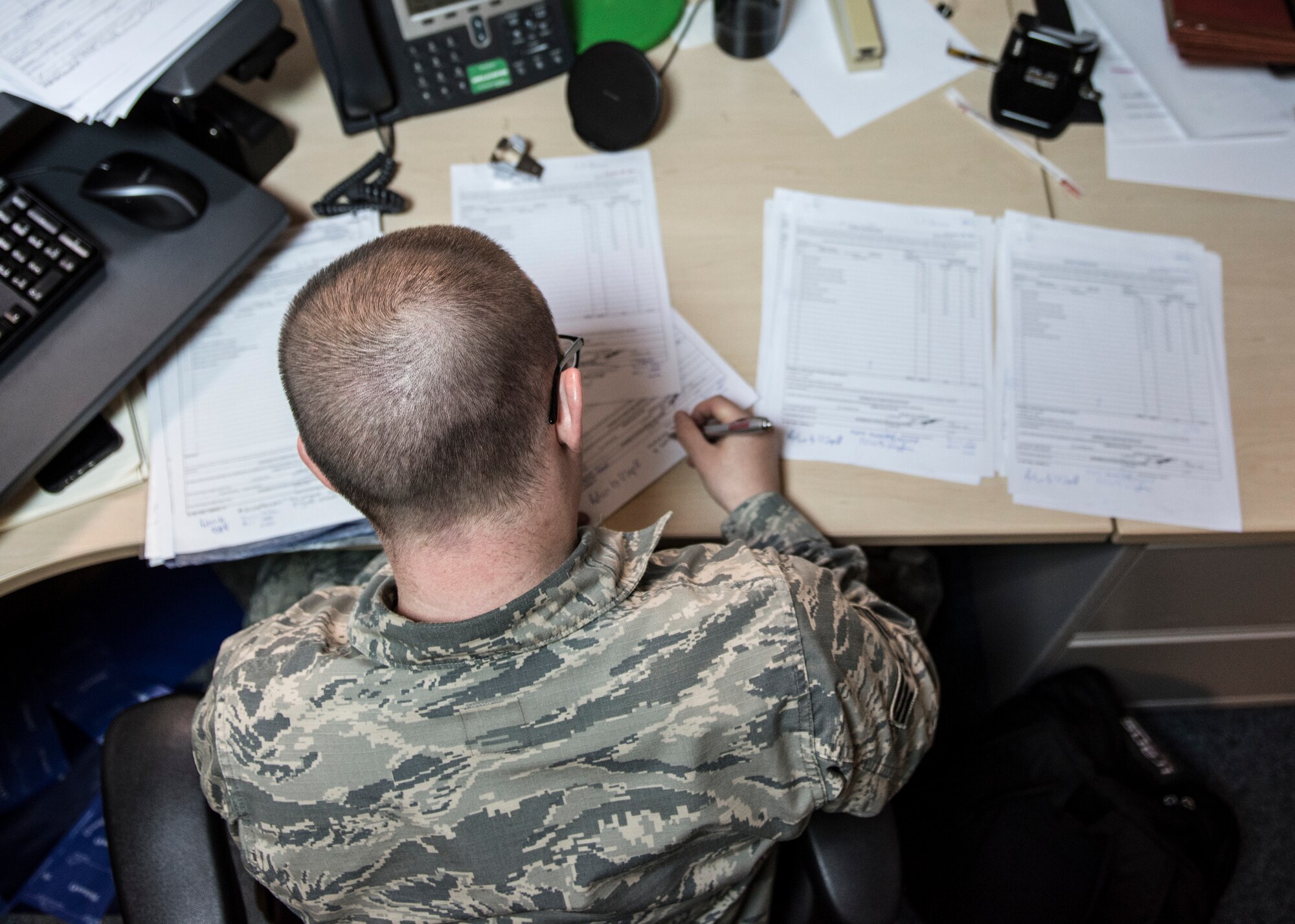 U.S. Air Force Senior Airman Charles Bower, 39th Contracting Squadron contracting specialist, fills out end of fiscal year requests at Incirlik Air Base, Turkey, Sept. 19, 2018.