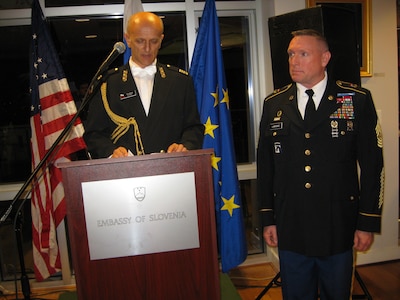 ​Slovenian Defense Attaché Col.  Ivan Mikuz awards Colorado National Guard Senior Enlisted Leader Command Sgt. Maj. Michael R. Lawrence the medal for multinational cooperation at the Embassy of the Republic of Slovenia June 23, 2015.  Lawrence has spent two decades helping build the partnership between Slovenia and Colorado as part of the National Guard State Partnership Program. (U.S. Air Force photo by Maj. Elena O'Bryan/Released)