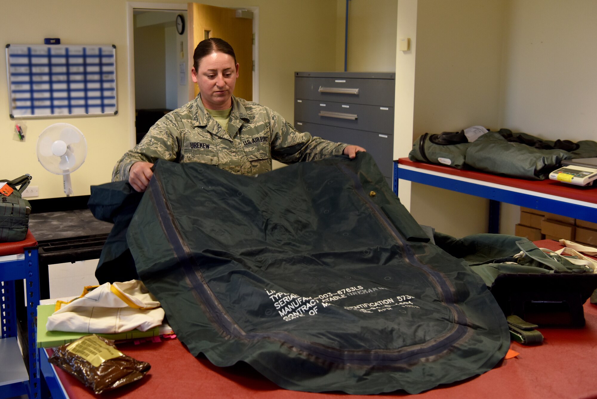 Tech. Sgt. Jessica Urekew, 48th Operation Support Squadron Aircrew Flight Equipment supervisor, inspects an emergency survival raft at Royal Air Force Lakenheath, England, Sept. 13, 2018. The peace of mind afforded to 48th Fighter Wing aircrew through efficiency and comfort during normal operations or survival and recovery during an emergency, is an invaluable contribution to the collective safety of Liberty Wing Airmen. (U.S. Air Force photo/ Senior Airman John A. Crawford)